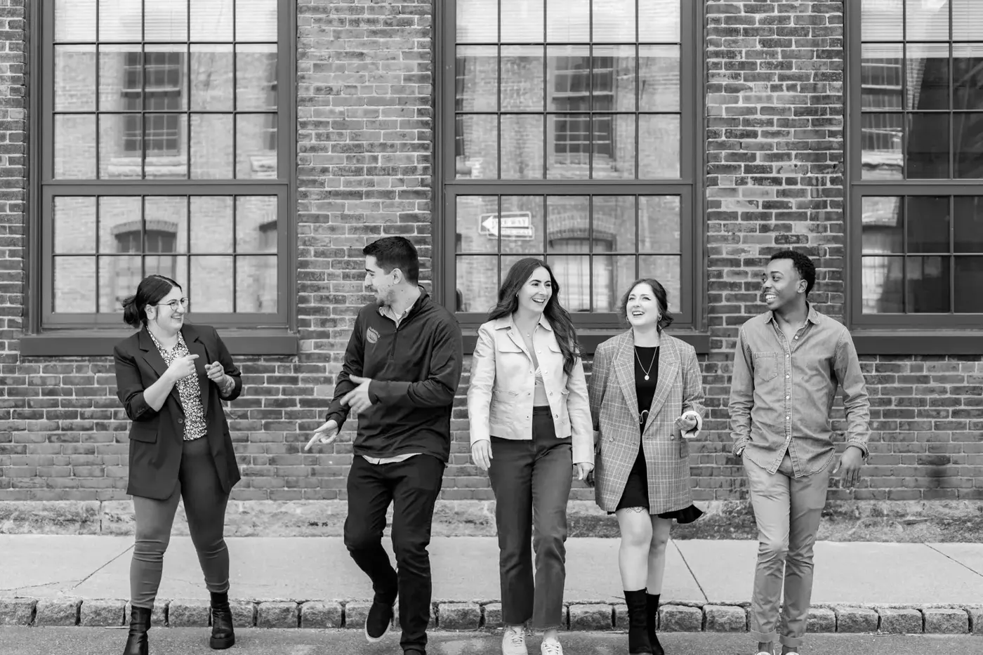 The BusySeed team outside a brick building